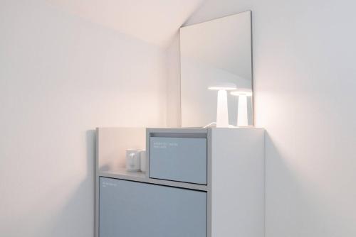 a refrigerator in a room with a mirror at 은행 아늑에어 대전역점 Aank Air Hotel Daejeon Station in Daejeon
