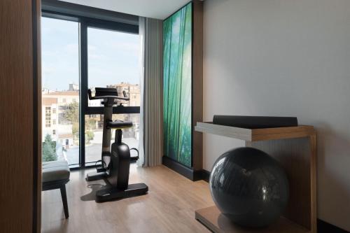 a room with a room with a exercise ball and a chair at The Westin Istanbul Nisantasi in Istanbul