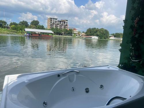 a bath tub sitting in the middle of a body of water at KeanKan Resort in Ban Chuk Kum