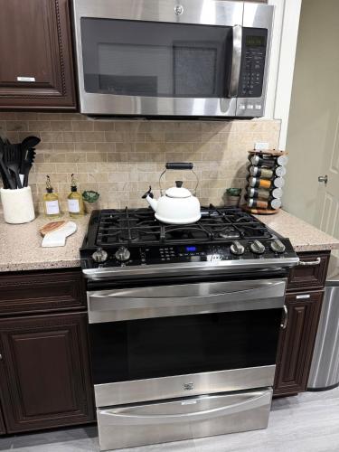 a kitchen with a stove with a microwave above it at Reset, Relax and Enjoy Fairfield, Napa in Fairfield