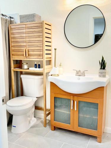 a bathroom with a sink and a toilet and a mirror at Reset, Relax and Enjoy Fairfield, Napa in Fairfield