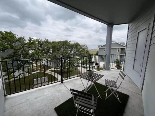 a patio with a table and chairs on a balcony at Peaceful Vacation Spot with Modern Touches and Amazing Ambiance in Leander