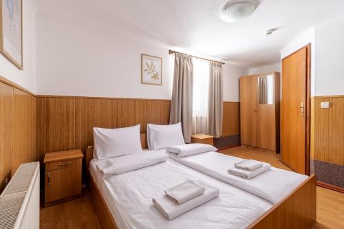 a bedroom with a large bed with two towels on it at Robert Hotel in Dragobrat