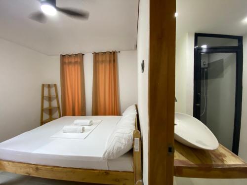 a bedroom with a bed and a bathroom with a mirror at MHARI Guest Rooms in San Juan
