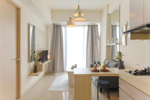 a kitchen with a counter and a window at Calma 1BR I at TreePark Apartment in Dadap