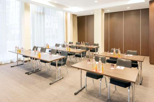 a conference room with tables and chairs in it at NH Collection Dresden Altmarkt in Dresden