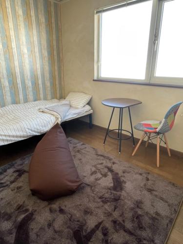 a bedroom with a bed and a pillow on the floor at TrainLineField in Tōbetsu