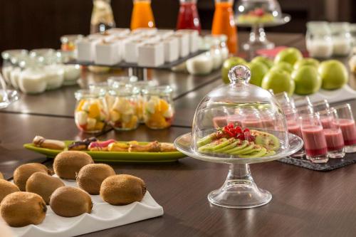 a table with plates of food and a plate of food at NH Collection Dresden Altmarkt in Dresden