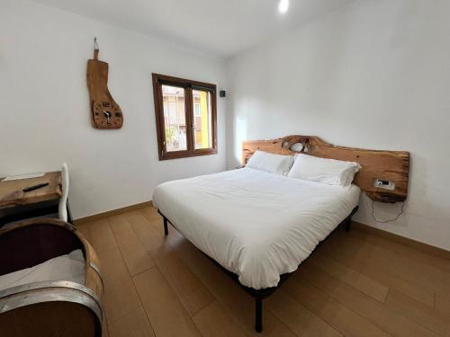 a bedroom with a bed with a guitar on the wall at B&B Didova in Gavoi