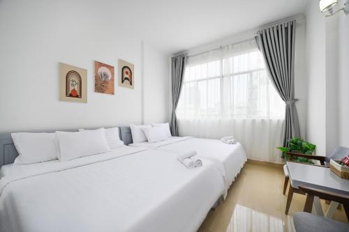 Postel nebo postele na pokoji v ubytování Amory Hotel Saigon Center