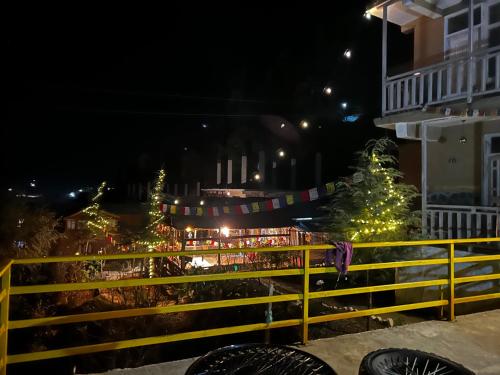 a group of christmas trees on a street at night at Happy Returns Home, Jibhi in Jibhi