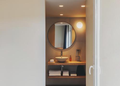 a bathroom with a sink and a mirror at Hotel Spa Mediterraneo Park in Roses