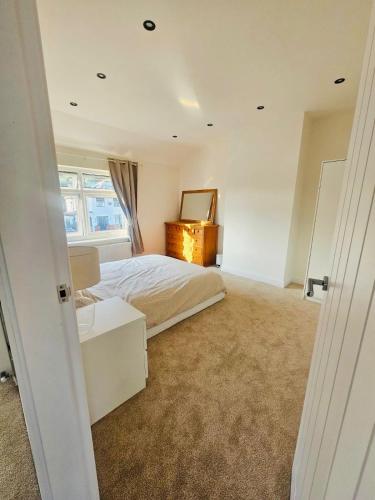 a bedroom with a bed with a dresser and a mirror at Luxe Residences - Preston in Preston