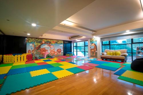 a living room with a lego rug on the floor at Hotel Maya Kuala Lumpur City Centre in Kuala Lumpur