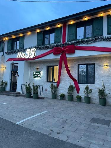 a building with a red bow in front of it at No. 55 in Buzau