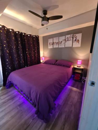 a bedroom with a purple bed with purple lighting at 3 bedroom with Hot Tub and Video game console 10 minutes from Rodeo Drive Beverly Hills in Los Angeles