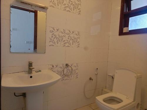 a bathroom with a sink and a toilet at Elephant Legacy Staycations in Mombasa