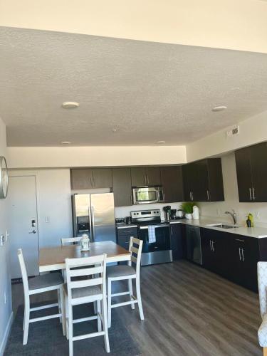 a kitchen with a table and chairs in a room at Resort-Inspired Bliss- Modern & Cozy Apartment in Salt Lake City