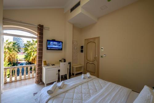 Ένα ή περισσότερα κρεβάτια σε δωμάτιο στο Olimpic Hotel