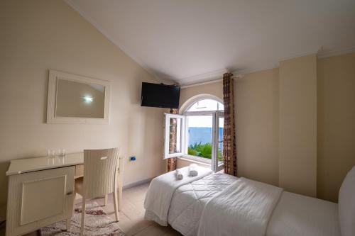 Ένα ή περισσότερα κρεβάτια σε δωμάτιο στο Olimpic Hotel
