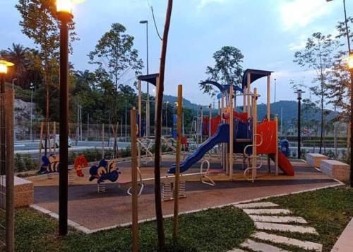 a playground with a slide in a park at Puncak Alam Homestay in Kampong Bukit Hijau