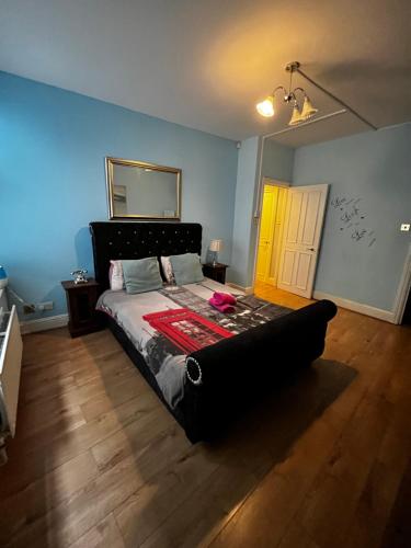 a bedroom with a bed with a couch in it at Keysan House in London