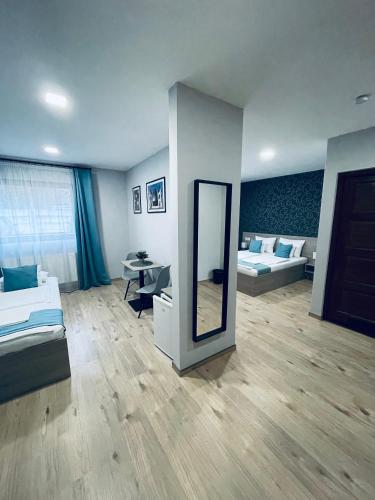 a room with two beds and a mirror at Thermal Apartman in Makó
