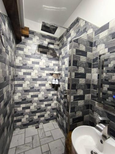 a bathroom with a sink and a shower at Sulu Sunset Beach Resort in Nauhang