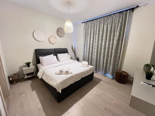 a bedroom with a large bed with two plates on it at Stylish 1BR Ground With Free Pool & Lagoon Access In Gouna in Hurghada
