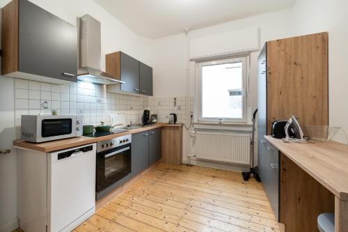 a kitchen with a counter top and a microwave at Ferienwohnungen in Bielefeld