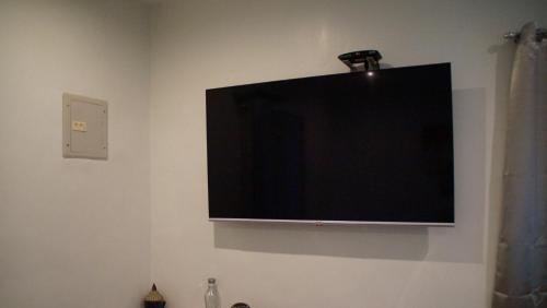a flat screen tv hanging on a wall at SBG Resort Lambug in Badian