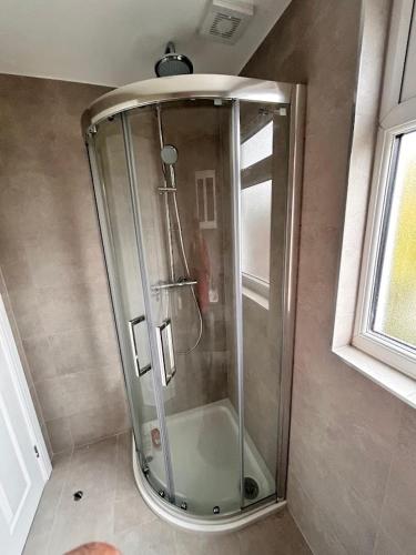 a shower in the corner of a bathroom at Park Street Accommodation Room 6 in Luton