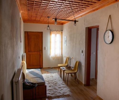 a room with a bed and a clock on the wall at Oreades Guesthouse in Koukouli