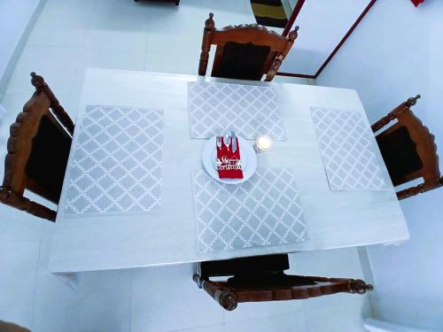 a white table with a cup on top of it at Alappuzha Family Vacation Villa - LAYANILA in Alleppey