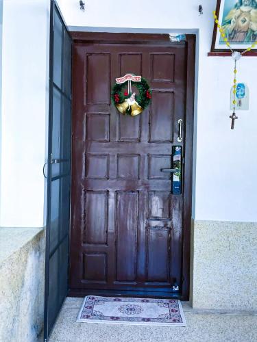 a brown door with a christmas wreath on it at Alappuzha Family Vacation Villa - LAYANILA in Alleppey