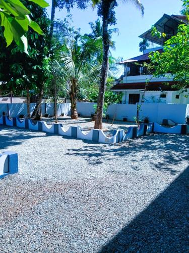 a resort with palm trees and a building at Alappuzha Family Vacation Villa - LAYANILA in Alleppey