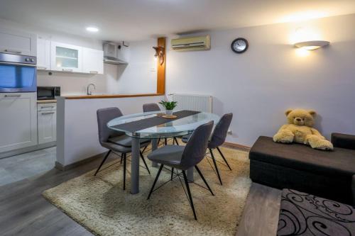 a teddy bear sitting on a table in a living room at Celine in Zaprešić