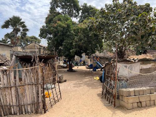 a village with a gate in a dirt road at Nguel du Saloum - Chez Abdou et Mar in Mar Lodj