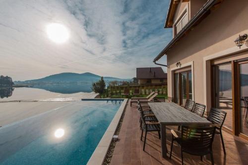 a patio with a table and chairs next to a swimming pool at House Sablja in Ogulin