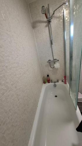 a white bath tub in a bathroom with a shower at Pine tree House in Mile End