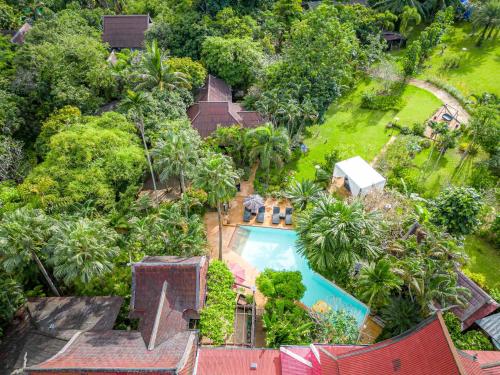 an aerial view of a house with a swimming pool at 11 Rooms in Chiang Dao