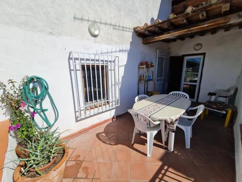 a patio with a table and chairs and a window at Amazing escape in tuscany in Chiesina Uzzanese