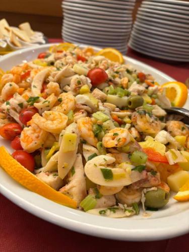 a plate of shrimp and vegetables on a table at Hotel Sporting in Casarsa della Delizia