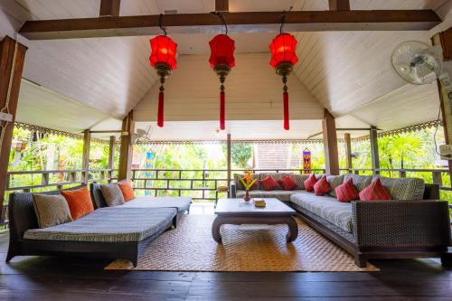 a living room with two couches and a table at 11 Rooms in Chiang Dao