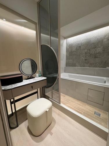 a bathroom with a toilet and a sink and a mirror at 享兜兜 in Tainan