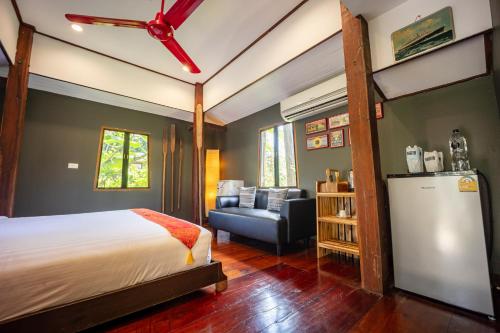 a bedroom with a bed and a living room at 11 Rooms in Chiang Dao