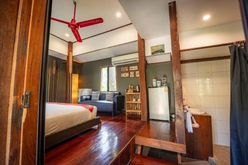 a bedroom with a bed and a living room at 11 Rooms in Chiang Dao