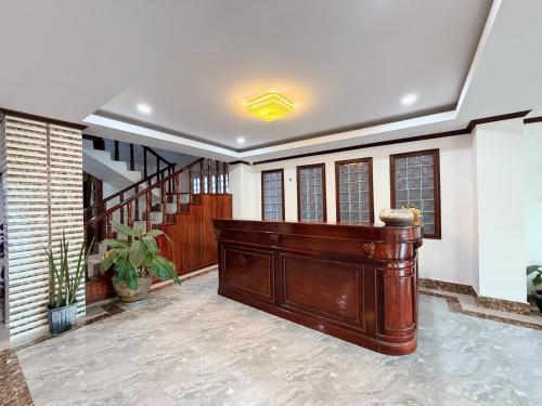 a large room with a large wooden door and stairs at Vangvieng Sisavang Hotel in Vang Vieng