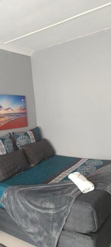 a bedroom with a bed in a room at Sunset Guest House in Roodepoort