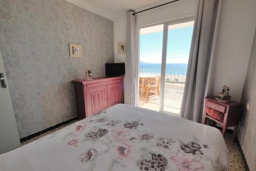 a bedroom with a bed and a balcony with the ocean at Delta Muga Silvia in Empuriabrava